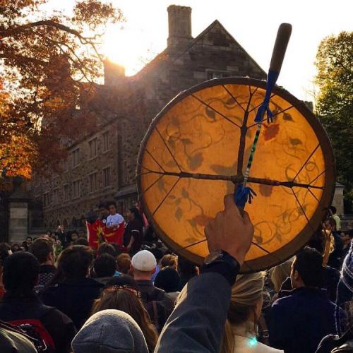 Professor Ned Blackhawk holding a hand drum in salute of the Yale Blue Feather Drum Group as they performed during the March of Resilience. [Photo credit: Tyler Rogers]